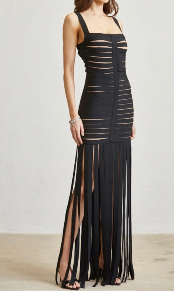 Woman wearing a black dress with cut-out design on a white background