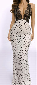 Long black lace dress with polka dot pattern on a white background